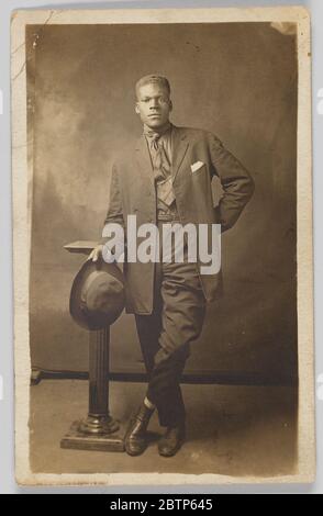 Fotopostkarte von Herrn Robinson. Fotografische Postkarte eines Mannes, der als Mr. Robinson identifiziert wurde. Robinson ist mit einem Hut und auf einer kleinen Säule gestützt abgebildet. Stockfoto