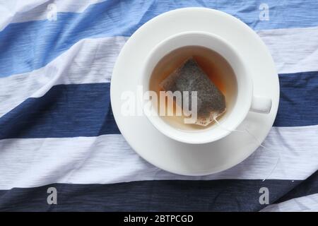 Tasse Tee mit Teebeutel auf Holztisch Stockfoto