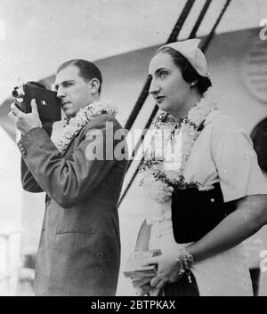 Royal Kameramann . Prinz Juan und seine Braut kommen auf Hawaii auf Flitterwochen-Tour an. Prinz Juan de Bourbon, Erbe mutmaßlich auf den spanischen Thron, Fotografieren der Tauchjungen von Honolulu Hafen, wenn mit seiner Braut, früher Prinzessin Maria Mercedes von Bourbon, er in Hawii auf Flitterwochen angekommen. 19 Dezember 1935 Stockfoto