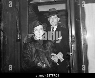 Berühmte Jockeys ab nach Amerika. Jack Sirrett, der Jockey, und seine Frau und Harry Wragg, ebenfalls ein berühmter Jockey und seine Frau, verließen Waterloo Station auf dem 'Aquitania'-Bootszug nach Amerika. Foto zeigt Harry Wragg und seine Frau in der Kutscheneinfassung von Waterloo. Januar 1938 Stockfoto