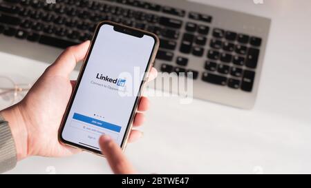 CHIANG MAI, THAILAND, 24. MAI 2020: EINE Frau hält Apple iPhone XS mit LinkedIn-Anwendung auf dem Bildschirm. Stockfoto