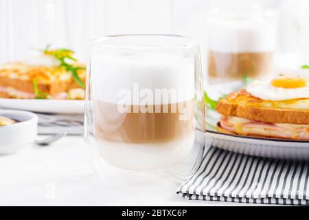 Kaffee Café Latte Macchiato in einem Glas auf hellem Hintergrund. Italienische Küche Stockfoto