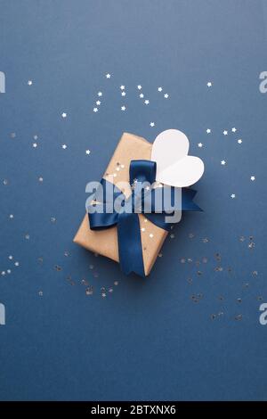 Blaues Thema Handwerk Geschenk-Box Geschenk mit klassischen blauen Band und weißen Herz-Form-Tag für Happy Fathers Day Nachricht, Urlaub, Weihnachten, weihnachten 2021 Stockfoto