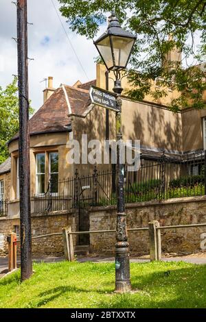 Ein historischer Lampentor hat ein öffentliches Wegweiser zum Iffley-Schloss im Dorf Iffley, nahe Oxford, Großbritannien Stockfoto