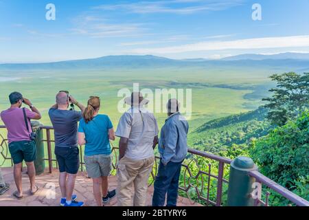 Touristen blicken in den Ngorongoro Krater Nationalpark mit dem Lake Magadi von der Aussicht. Schöne Landschaft Landschaft in Tansania, Afrika Stockfoto