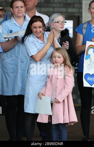 Unterstützer und NHS-Mitarbeiter vom Aintree University Hospital in Liverpool applaudieren zusammen, um lokale Helden während des landesweiten Clap for Carers am Donnerstag zu begrüßen, um NHS-Arbeiter und Betreuer zu unterstützen, die gegen die Coronavirus-Pandemie kämpfen. Stockfoto