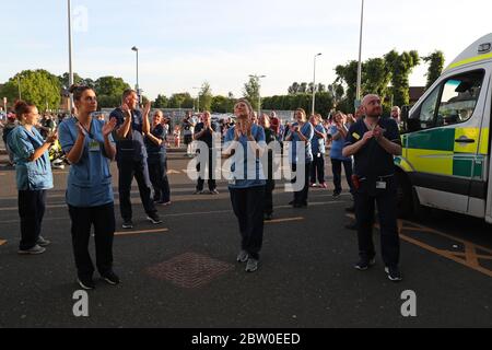 Mitarbeiter des Queen Elizabeth University Hospital in Glasgow versammeln sich, um den Applaus zu vereinigen und lokale Helden während des landesweiten Clap for Carers zu begrüßen, der am Donnerstag die NHS-Mitarbeiter und Betreuer bei der Bekämpfung der Coronavirus-Pandemie anerkennt und unterstützt. Stockfoto