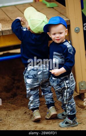 2 Zwillingsbrüder spielen zusammen auf dem Spielplatz Stockfoto