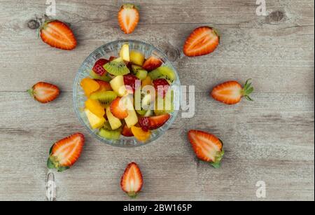Obstsalat in einem Glasplatte und Erdbeerbeeren. Flaches Layout, Kopierer Raum. Reichste Quelle von Nährstoffen und Vitaminen. Stockfoto