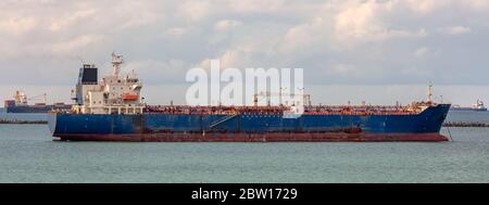 Öltanker im Panamakanal im Vordergrund. Einige andere Tanker im Hintergrund mit Weichstellung. Wolken und blauer Himmel als Hintergrund Stockfoto