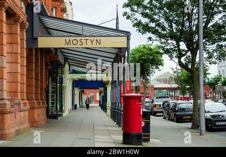 Llandudno, Großbritannien: 27. August 2019: Geschäft mit Glasfassaden und Galerie in der Vaughan Street mit gusseisernen Vordönen. Stockfoto