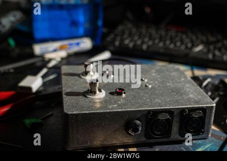 Ein speziell angefertigtes robustes Pedal zum Schalten von Audio, aus Stahl. Mit Stomp-Box-Schaltern, XLR-Anschlüssen und roten LED-Leuchten. Stockfoto