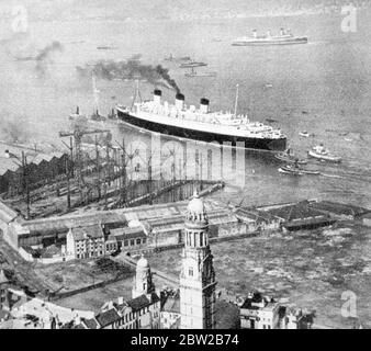 Die RMS Queen Mary wird von Schlepper gezogen. Stockfoto