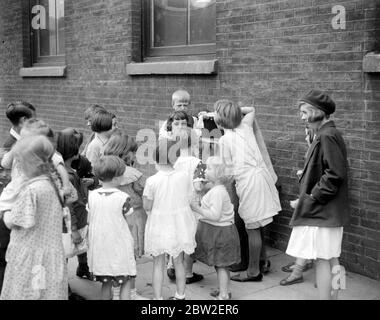 Kinder beobachten eine Punch & Judy Show. 1933 Stockfoto