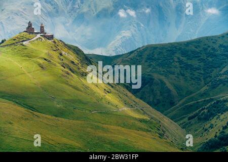 Die Dreifaltigkeitskirche Gergeti thront auf einem Berggipfel in Stepantsminda, Georgien Stockfoto