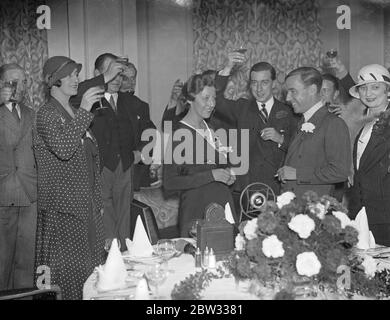 Nach der Hochzeit von Miss Amy Johnson und Mr J A Mollison wird die Gesundheit der Braut und des Bräutigams geröst. Nach ihrer Ehe in St Georges Church Hanover Square, london, Miss Amy Johnson und Mr J A Mollison, hielt einen Empfang im Grosvenor House, London. Gäste mit Lady Drogheda auf der linken Seite , Toasting die Gesundheit des Brautpaares ( in der Mitte ) in der Rezeption . 29 Juli 1932 Stockfoto