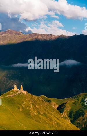 Die Gergeti Trinity Kirche bei Sonnenuntergang. Höhe 2170m, nahe Mount Kazbek, Georgia Stockfoto