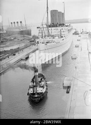 RMS Empress of Britain betritt das Trockendock am Gravierdock von King George V, nachdem es mit einem Frachtboot namens Kapristan kollidierte, das ihren Bogen beschädigt hat. 20 Juli 1935 Stockfoto