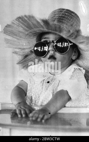 Die Kinnsqualen sehen die Welt durch rosarote Brillen. Yvonne Dionne trägt rosarote Brille. 22. September 1935 Stockfoto