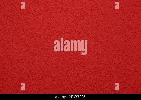 Helle, bunte Betonwand Textur, Hintergrund gemalt - rote Farbe. Tapetenputz. Stockfoto