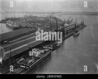 Vorbereitung ' Queen Mary ' s ' Liegeplatz in Southampton . Der Queen Mary ' s Liegeplatz im Ocean Dock in Southampton wird vorbereitet, um den riesigen Liner zu empfangen. Das Dock wird neu gestrichen und neue Poller werden eingebaut. Foto zeigt, ein Blick von einem Kran auf die "Queen Mary" s Liegeplatz im Ocean Dock in Southampton vorbereitet. 26 März 1936 Stockfoto