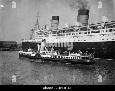 Königin Mary hat Besucher aus dem Osten. Tausende von Osterurlaubern nutzen die Gelegenheit, die der Urlaub bietet, um das neue Linienschiff Queen Mary in Southampton zu inspizieren. Die Lustdampfer bieten ausgezeichnete Grand Stände. Foto zeigt, Vergnügen Dampfer Passagiere bekommen eine Nahaufnahme der Queen Mary in Southampton. 11. April 1936 Stockfoto