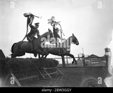 Kavallerie Proben für Royal Turnier . Unsattling ihre Reittiere über atemberaubende Sprünge und die Durchführung der schwierigsten Leistungen mit hervorragenden Reitsport, Troopers der Equitation School in Weedon, Northamptonshire, sind reheasring für die Royal Tournament, die bei Olympia im nächsten Monat eröffnet. Die Männer, die teilnehmen, werden von kleinen Kavallerieeinheiten der britischen Armee gepflückt. Foto zeigt, Sättel hoch in der Luft gehalten, Troopers der Equitation School einen schwierigen Sprung. 14. April 1936 Stockfoto