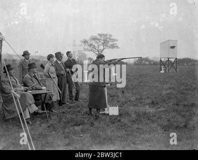 Frau Clay Pigeon Shooting Champion tritt in der Meisterschaft bei Northolt Mrs an. I . Grosvenor of Wood Green, der noch nie in der Women's British Championship geschlagen wurde und auf Augenhöhe mit Männern konkurriert, nimmt an der jährlichen Skeet (Tontaubenschießen) Meisterschaften im Northolt Park Teil. Ihr Mann und ihre Tochter Betty sind ebenfalls bekannte Schützen. Foto Zeigt : Frau . I . Grosvenor, die Frauen ' s Champion, Schießen von anderen Wettbewerbern beobachtet. Mai 1936 Stockfoto