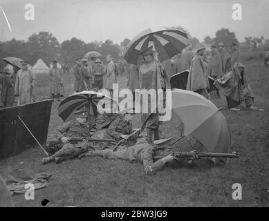 Schuljunge Marksmen schießen in EINER Flut bei Bisley. Schullenschüler schießen im sintflutartigen Regen, für den Ashburton Shield in Bisley, Surrey. Siebzig - neun Teams aus vielen berühmten öffentlichen Schulen konkurrierten in der Schießerei. Foto zeigt : Jungen von Exeter School [ Eton College ?] Nehmen Sie an der Bisley 9 Jul 1936 Stockfoto