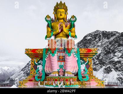 Goldene Maitreya Buddha in Ladakh Indien Statue sitzt in Schnee Berge im Diskit Kloster, Nubra Valley. Der Ort ist berühmt in Nubra Tal & Ladakh. Stockfoto