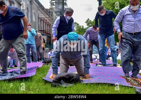 Beten mit medizinischen Masken vor der Blauen Moschee. Am ersten Freitag beten, namaz nach der Sperre in Istanbul. Muslime beten gemeinsam für Heilung Stockfoto