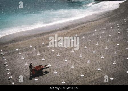 Genua, Italien. Mai 2020. Ein Mann arbeitet an einem Strand in Genua, Italien, 29. Mai 2020. Nachdem einige Beschränkungen der Personenbewegung, die seit März 10 mit der Sperrung auferlegt wurden, in den letzten Wochen allmählich aufgehoben wurden, war das Reisen innerhalb derselben Wohnregion erst ab Mai 18 erlaubt. Der nächste Schritt im offiziellen Zeitplan der Regierung wäre in der Tat, den Umzug zwischen den italienischen Regionen bis zum 3. Juni wieder aufzunehmen. Kredit: Federico Tardito/Xinhua/Alamy Live News Stockfoto