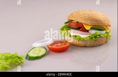 Zubereitung von Sandwiches zum Frühstück. Leckere Burger auf einer Glasfläche mit Reflexion. Stockfoto