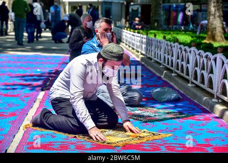 Beten mit medizinischen Masken vor der Blauen Moschee. Am ersten Freitag beten, namaz nach der Sperre in Istanbul. Muslime beten gemeinsam für Heilung Stockfoto