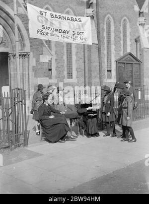 Ein kleines Mädchen gibt Geld für die Sammler für St. Barnabas Kirche in Eltham, Kent. 1938 Stockfoto