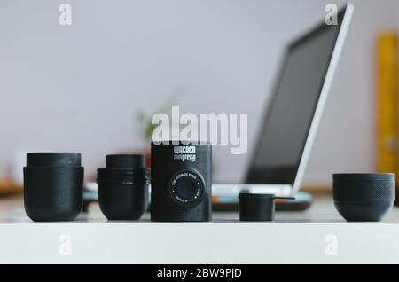 Ein illustratives Editorial der Wacaco Minipresso Maschine, in der Sie Espresso unterwegs im Home Office-Hintergrund zubereiten können. Stockfoto