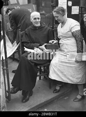 Der Reverend E O Iredell in der Veranda der St. Clement ' s Kirche, Barnsbury, London, um Spenden für die Kirche Fonds zu sammeln. 28 Mai 1934 Stockfoto