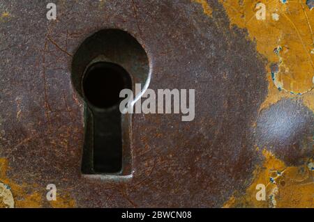 Nahaufnahme des rostigen Metallschlüssellochs auf der alten Metallbox Stockfoto