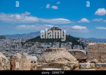 Luftbild des Lycabettus und der Stadt Athen, Blick vom Akropolis-Hügel in Griechenland. Blauer Himmel mit Wolken, sonniger Frühlingstag. Stockfoto