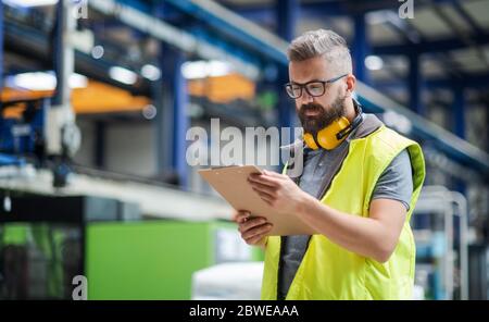 Techniker oder Ingenieur mit Kopfhörer in der Industriefabrik. Stockfoto