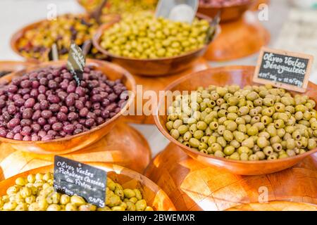 Marinierter Knoblauch und Oliven auf dem provenzalischen Straßenmarkt in der Provence, Frankreich. Verkauf und Kauf. Stockfoto