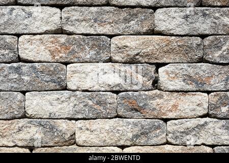 Grob gehauen Ziegel einer Stützmauer, Muster, Textur oder Hintergrund Stockfoto