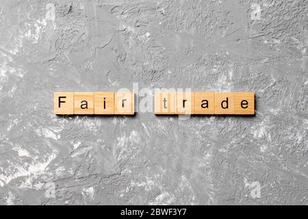 Fair Trade Wort geschrieben auf Holzblock. Fair Trade Text auf Zementtisch für Ihre Desing, Konzept. Stockfoto