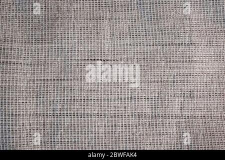 Die Textur des rauen Stoffes aus der mattbraunen Farbe. Hintergrund. Textur aus hellbeige Stoff Matten. Nahaufnahme. Stockfoto