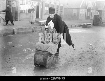 Little Hollanders on the Ice zwei junge Hollanders, die in der Woche vom 10. Dezember 1921 das Beste aus den Eislaufbedingungen der gefrorenen Wasserstraßen gemacht haben Stockfoto