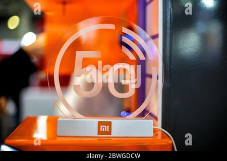Moskau, Russland - 04. Oktober 2019: 5g weiße Ikone xiaomi auf transparenten Kunststoffen. Orangefarbener Hintergrund in Unschärfe. Nahaufnahme, Vorderansicht. Stockfoto