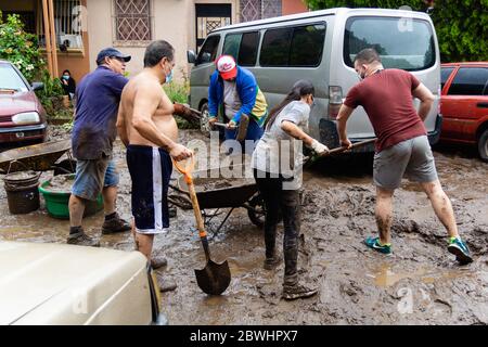 Mejicanos, El Salvador. 31. Mai 2020 - mehrere Nachbarn reinigen und entfernen den Schlamm und Trümmer durch den tropischen Sturm Amanda verlassen. Stockfoto