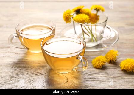 Tassen gesunden Löwenzahn Tee auf Holzhintergrund Stockfoto