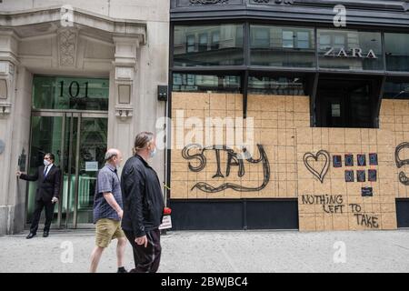 New York, Usa. Mai 2020. Menschen, die nach den Protesten gegen die Brutalität der Polizei in den letzten Nächten an einem vernagelten Ladenlokal vorbeigingen. Ein großer polizeibrutalzug, der Gerechtigkeit für die Ermordung von George Floyd forderte, begann friedlich in Brooklyn und endete in Manhattan mit den ersten Fällen von Plünderungen seit Beginn der Proteste in der Stadt. Quelle: SOPA Images Limited/Alamy Live News Stockfoto