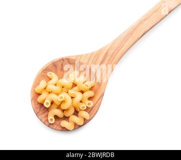 Löffel mit ungekochten Pasta auf weißem Hintergrund Stockfoto